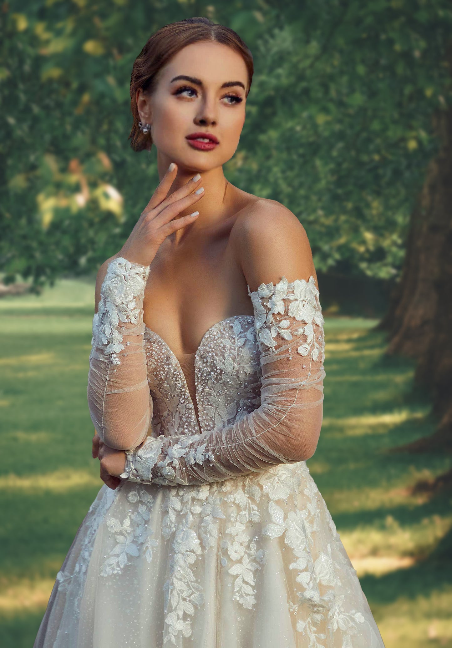 Breathtaking A-line has a plunging sweetheart bodice with pearl and crystal beading and floral embroidered appliqués.