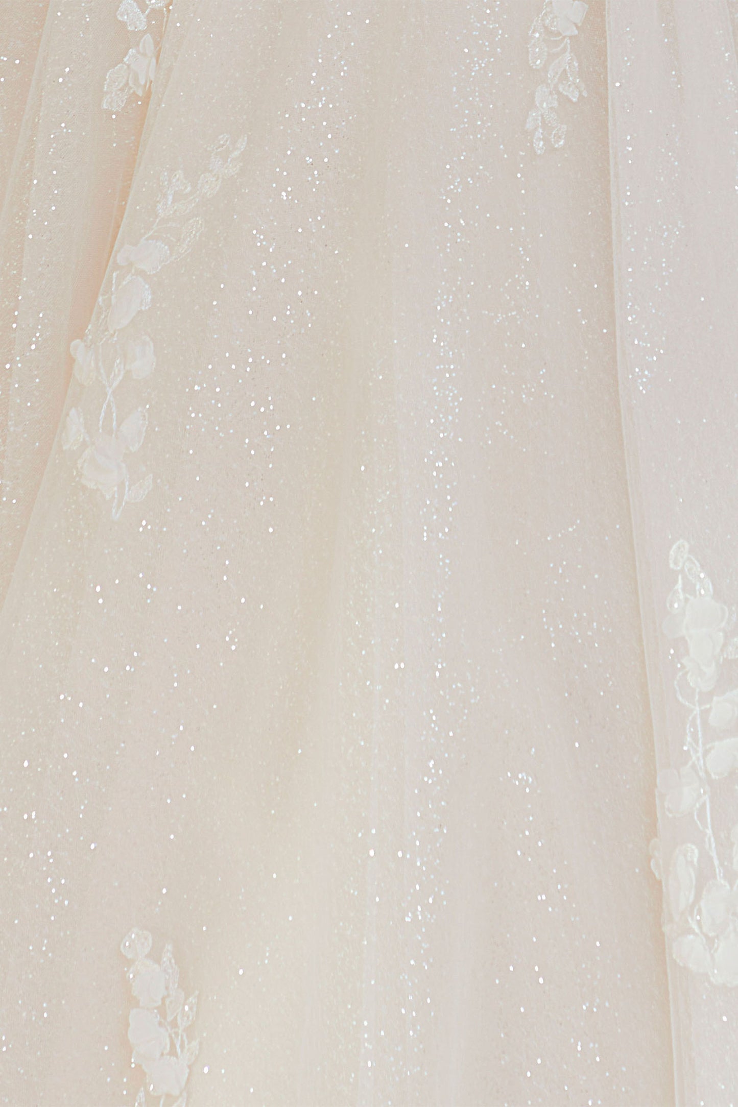 Dreamy ball gown has frosted embroidery with 3D petals and a sheer, draped corset bodice.